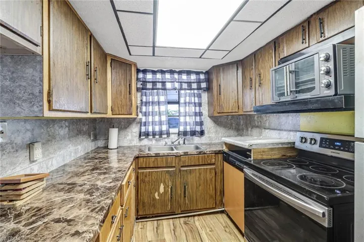 Kitchen featuring stainless steel appliances, light wood-type flooring, and sink