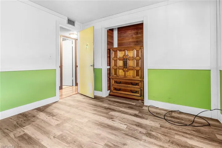 Unfurnished room with hardwood / wood-style flooring