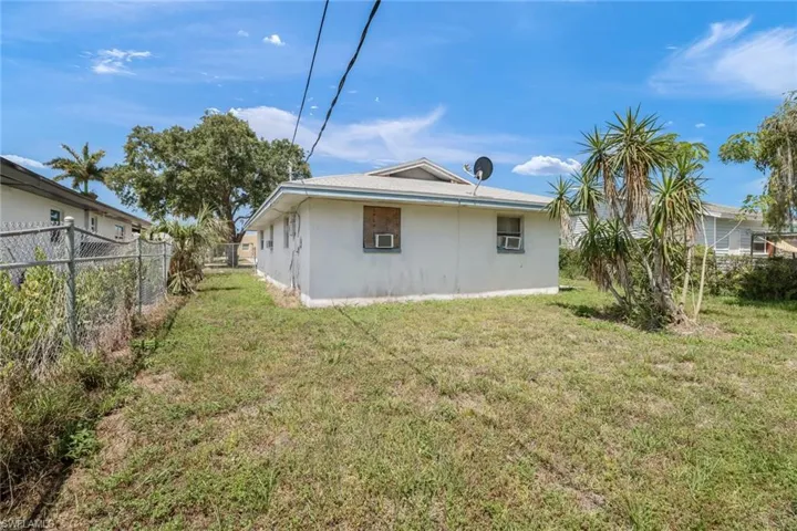 Back of property featuring a lawn