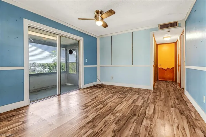 Spare room with ceiling fan and wood-type flooring