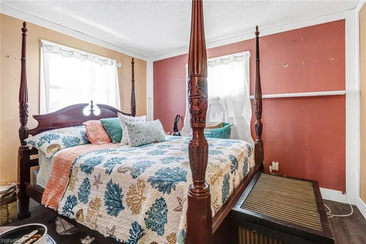 Bedroom featuring hardwood / wood-style flooring and a textured ceiling