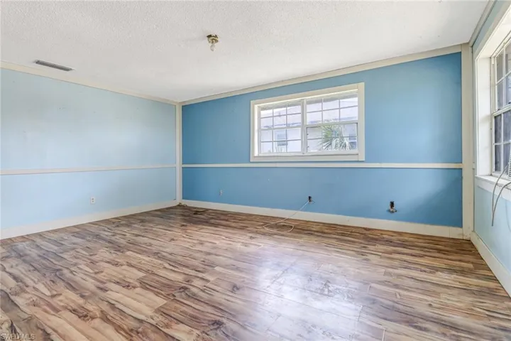 Spare room with hardwood / wood-style flooring and a textured ceiling