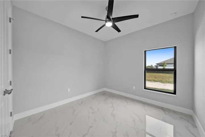 Unfurnished room featuring ceiling fan