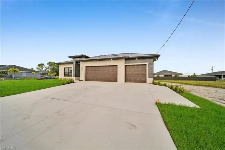 Prairie-style home featuring a garage and a front lawn