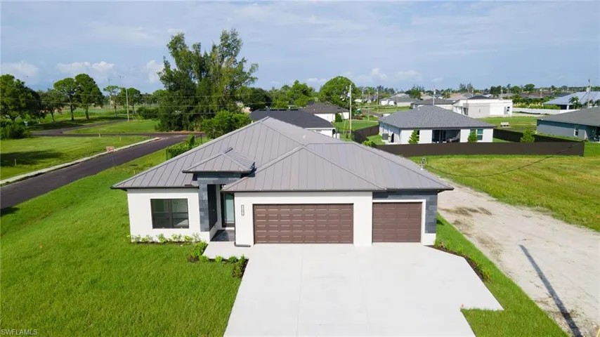View of front of house with a front lawn and a garage