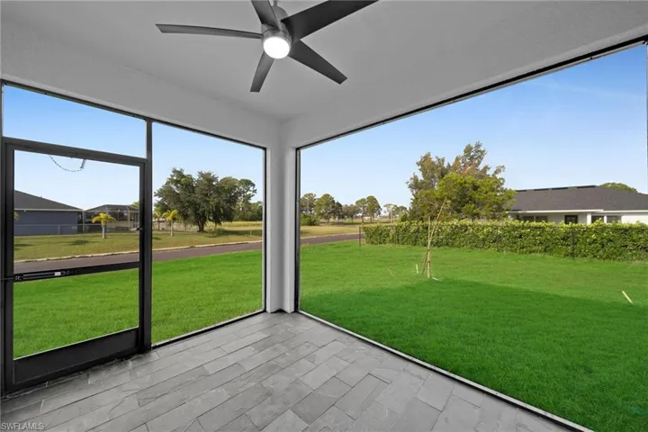 Unfurnished sunroom featuring ceiling fan