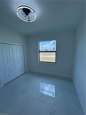 Empty room featuring marble finish floor and baseboards