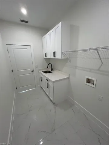 Laundry room featuring marble finish floor, visible vents, cabinet space, and hookup for a washing machine