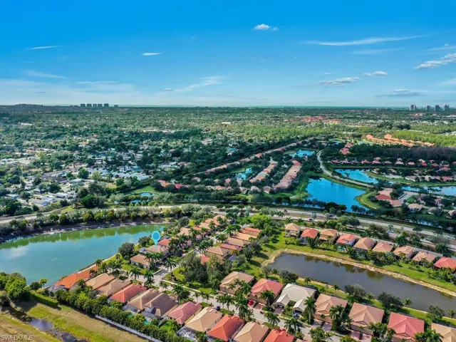 Aerial view of property's location with nearby suburban area and a large body of water