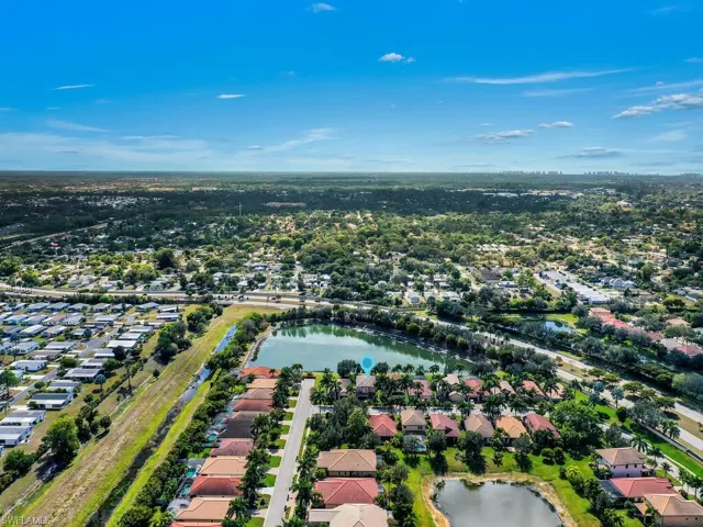 Aerial overview of property's location with nearby suburban area and a nearby body of water