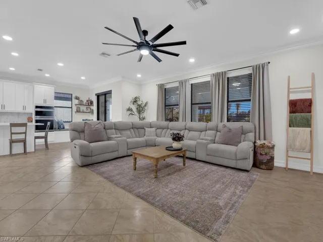 Living area featuring recessed lighting, crown molding, and a ceiling fan