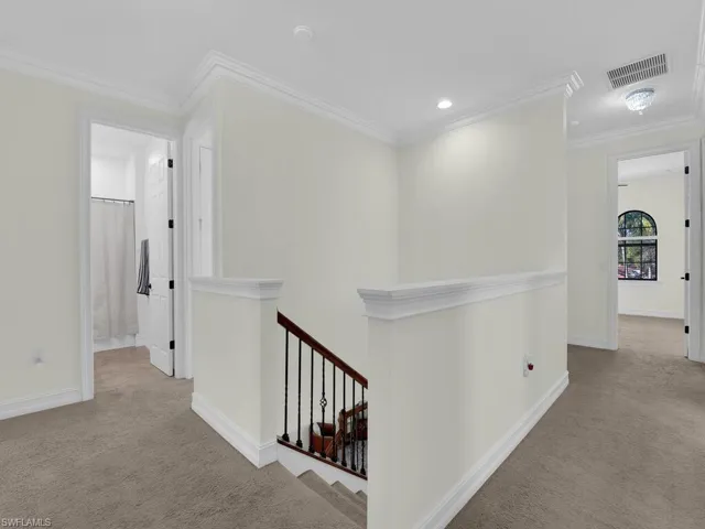 Corridor featuring carpet, an upstairs landing, ornamental molding, and recessed lighting