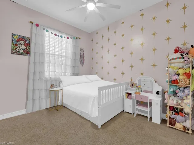 Carpeted bedroom with ceiling fan