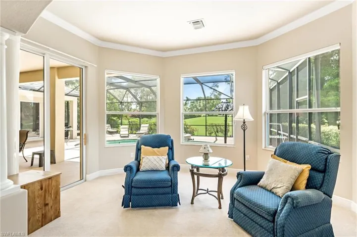 Primary Bedroom featuring large windows and glass sliding doors, providing access to an exterior screened patio