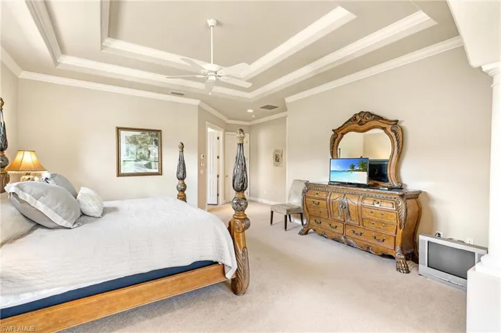Recessed ceiling featuring decorative trim and a ceiling fan