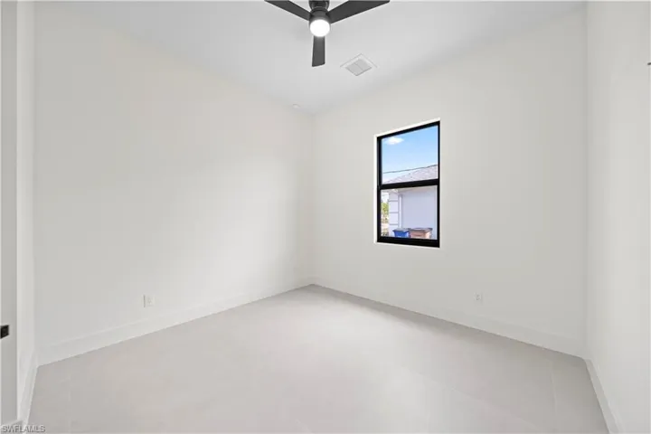 Unfurnished room with baseboards and ceiling fan