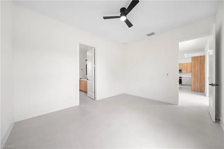 Unfurnished room with baseboards and ceiling fan