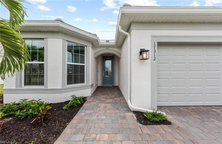 View of exterior entry featuring a garage