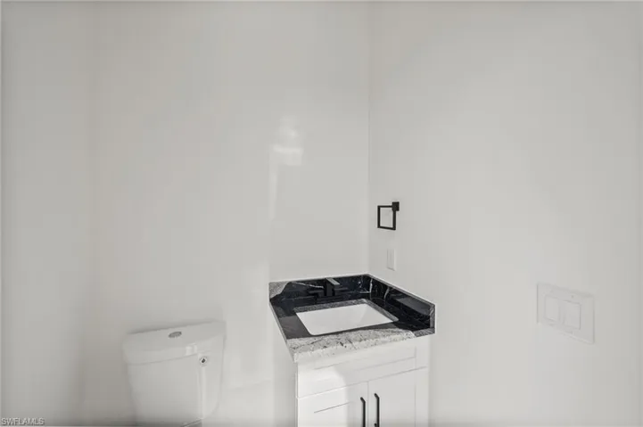 Half bath featuring toilet and vanity