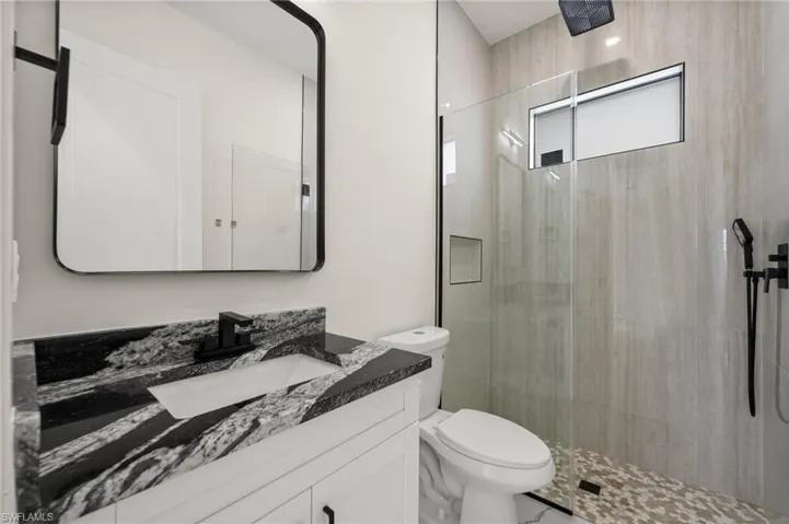 Bathroom with vanity and a shower stall