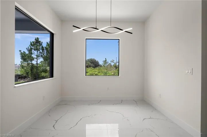 Empty room with baseboards and marble finish floors