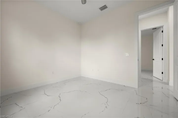 Empty room with light marble finish floors and baseboards
