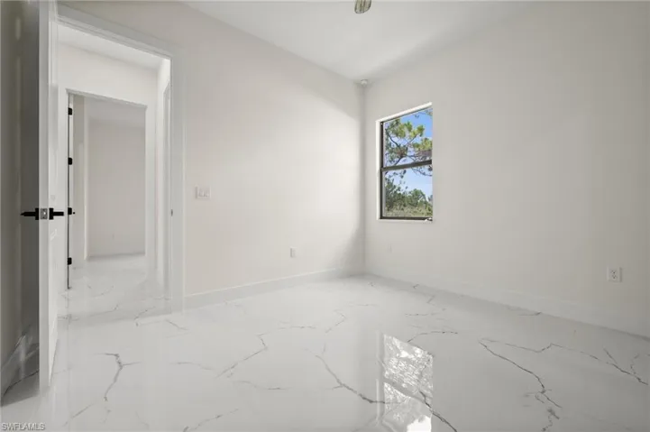 Spare room featuring marble tiled floors