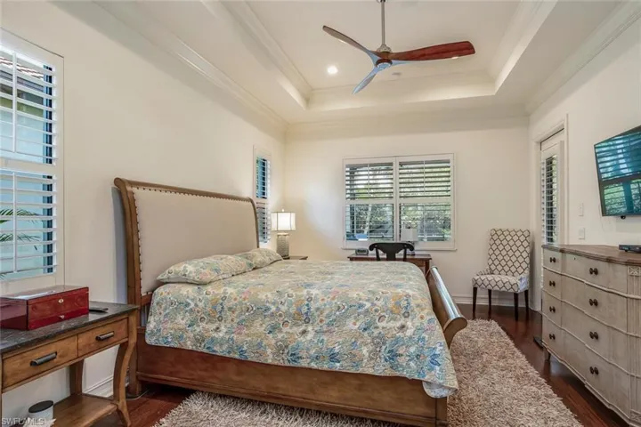 Master Bedroom, tray ceiling, recessed lighting, plantation shutters & separate entry door to lanai