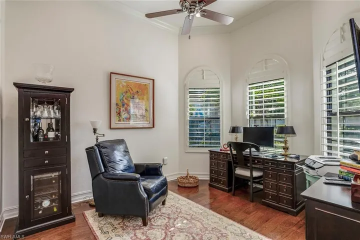 Den w/ LV flooring, ceiling fan, bay windows, plantation shutters