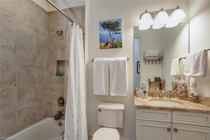 Full bathroom featuring shower / tub combo and vanity