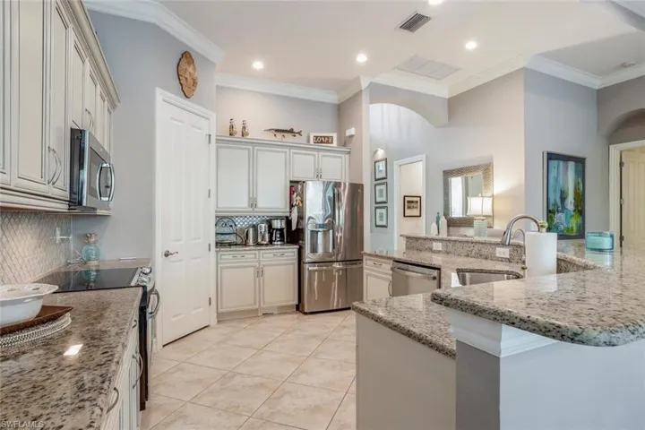 Kitchen featuring appliances with stainless steel appliances, crown molding & walk-in pantry