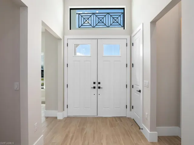 Double entry doors with glass detail and over-door transom window.
