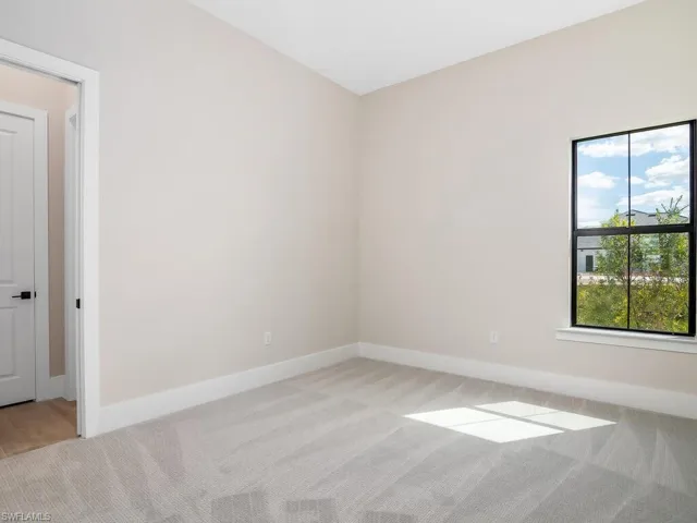 Additional guest bedroom at rear of home includes an ensuite bath which leads directly to the pool.