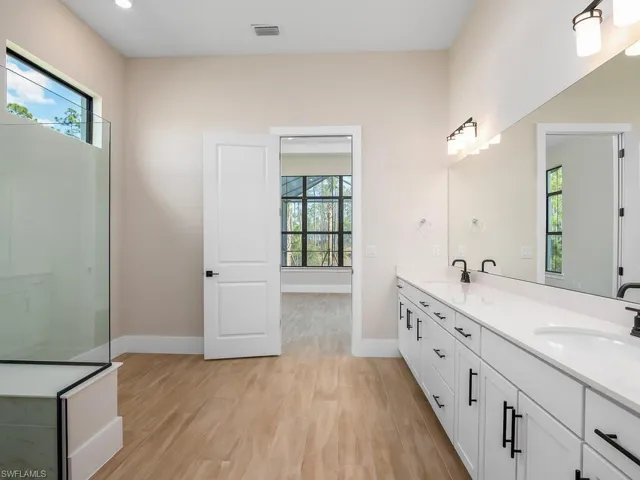 Spacious primary bath with dual sinks, linen closet, and plenty of cabinet space.