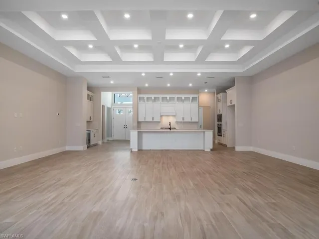 Aventura floor plan features an open kitchen, dining and great room with high coffered ceilings.