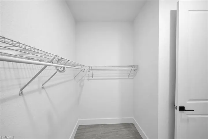Walk in closet featuring light tile patterned floors