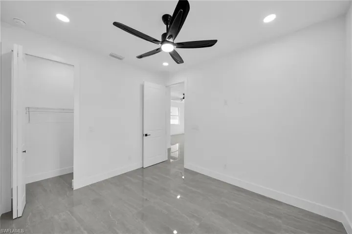 Unfurnished bedroom featuring a ceiling fan and recessed lighting