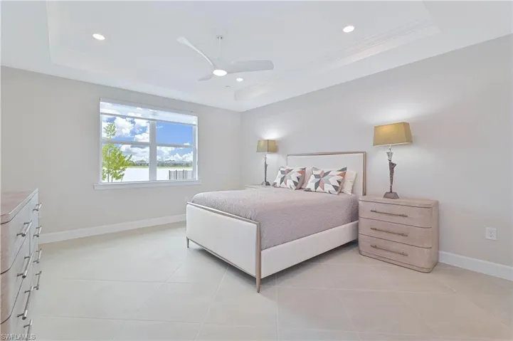 Bedroom featuring a ceiling fan, light tile patterned flooring, ornamental molding, and recessed lighting