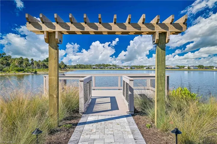 Dock with a pergola and a water view