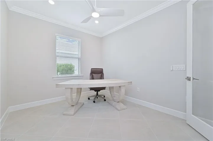 Office space with crown molding, recessed lighting, light tile patterned flooring, and a ceiling fan