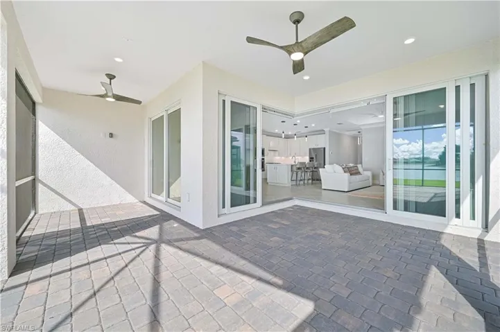 View of patio / terrace featuring ceiling fan and a sunroom