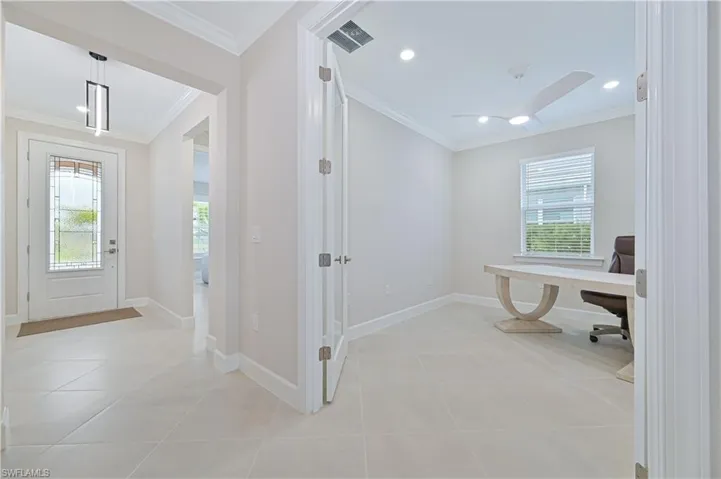 Foyer entrance with ornamental molding, recessed lighting, light tile patterned floors, and ceiling fan