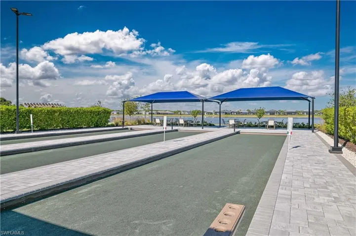 View of home's community featuring a game area and a water view