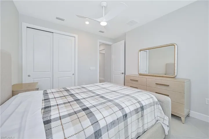 Bedroom featuring a ceiling fan, a closet, and tile patterned flooring