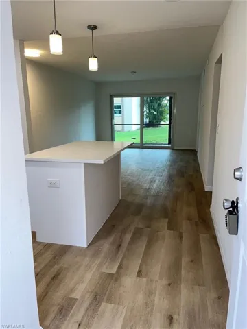Hall with wood finished floors and baseboards