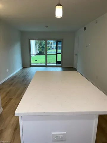 Spare room with baseboards and light wood finished floors