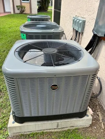 Exterior view of a cooling unit and stucco siding