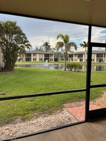 View of grassy yard with a water view