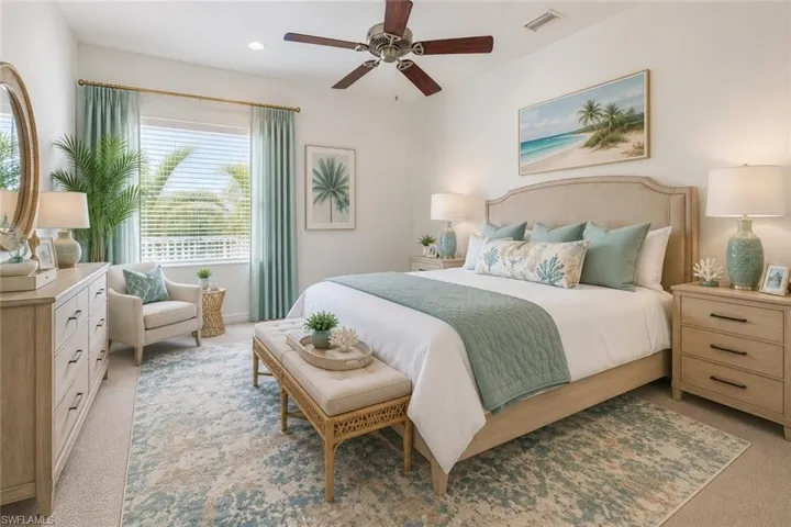 Bright bedroom featuring a large window with horizontal blinds and draperies. Furnishings virtually Staged