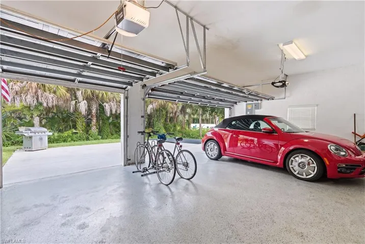Three-car garage featuring automatic openers and durable epoxy flooring